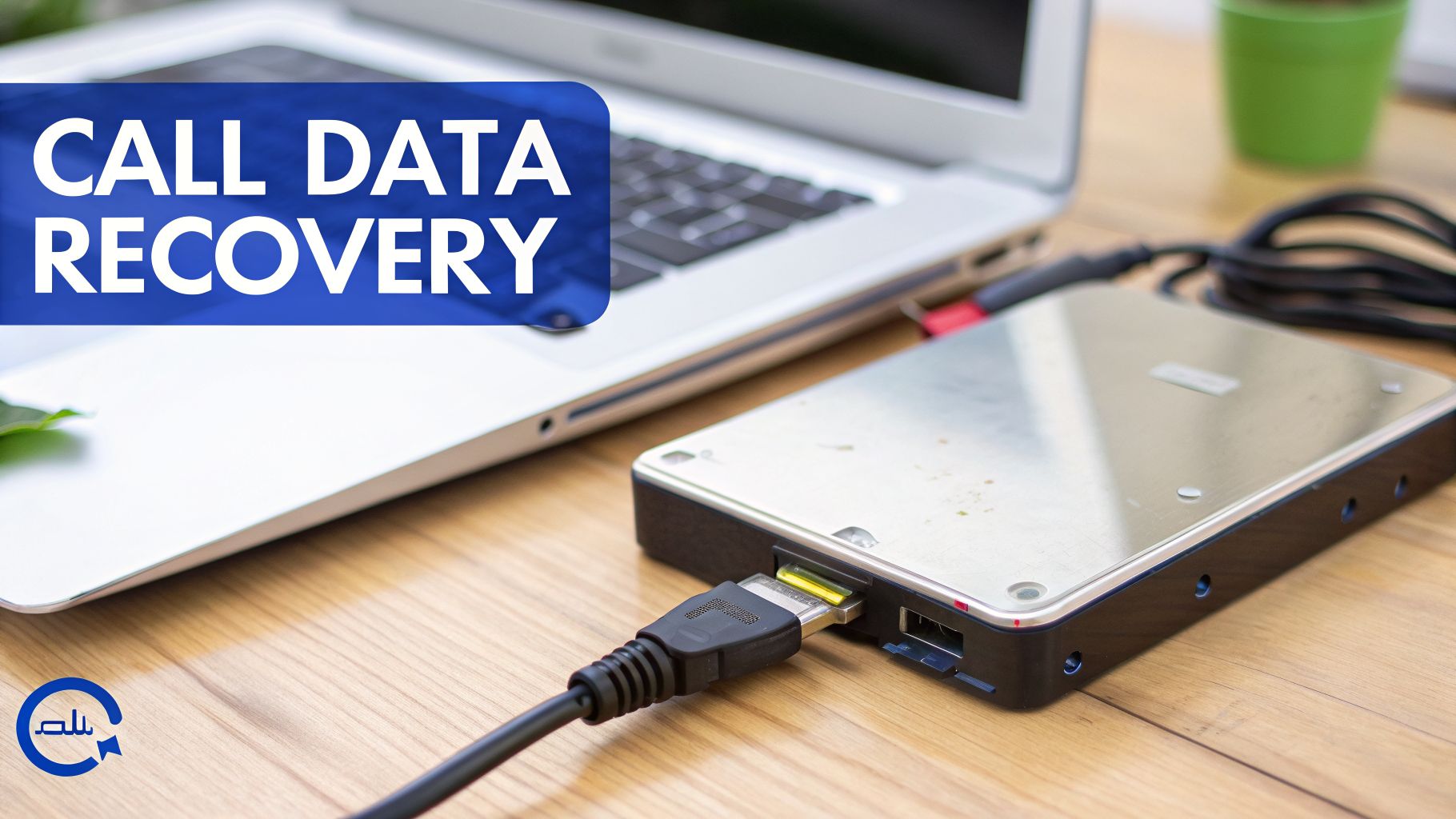 An external hard drive connected to a laptop on a wooden desk with a 'CALL DATA RECOVERY' overlay.